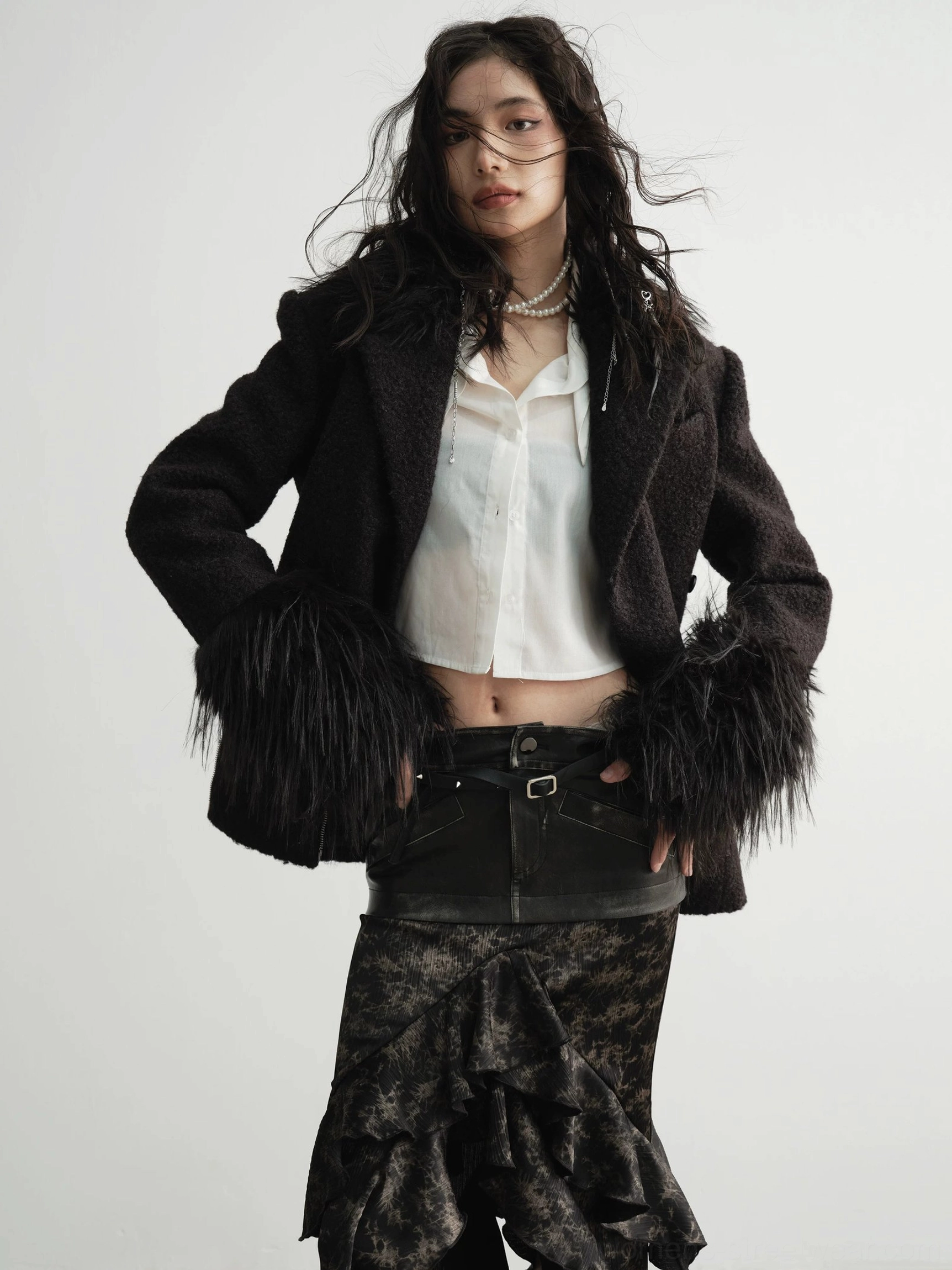 Front view of a tailored faux fur cuff coat styled with a cropped white shirt and leather mini skirt for a modern Y2K streetwear outfit