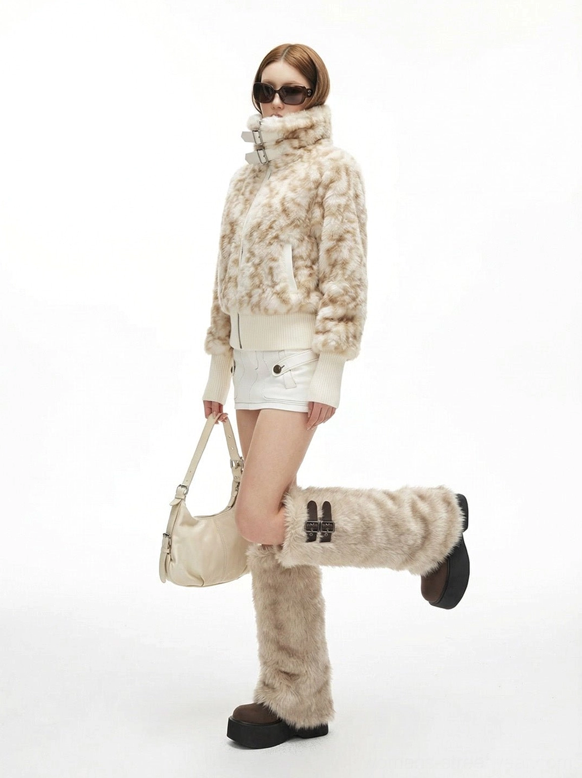 Model leg-lifted side view showing the shape of faux fur double-buckle platform tall boots