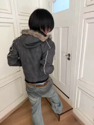 Back view of a cropped faux fur hood PU jacket showing silver contrast sleeve piping and urban Korean streetwear styling