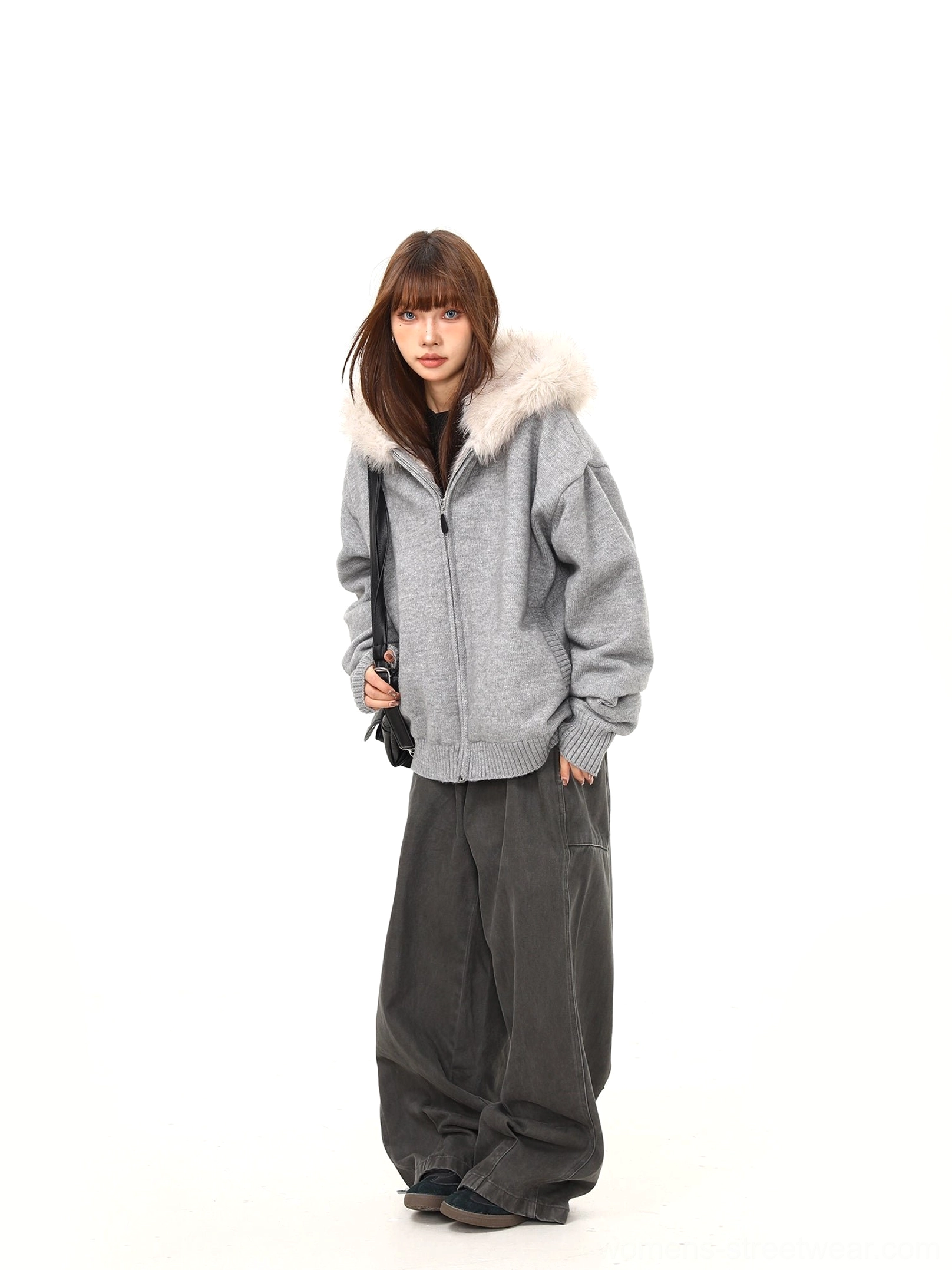 Women's oversized gray zip-up knit hoodie jacket showing off-white faux fur hood trim and ribbed hem