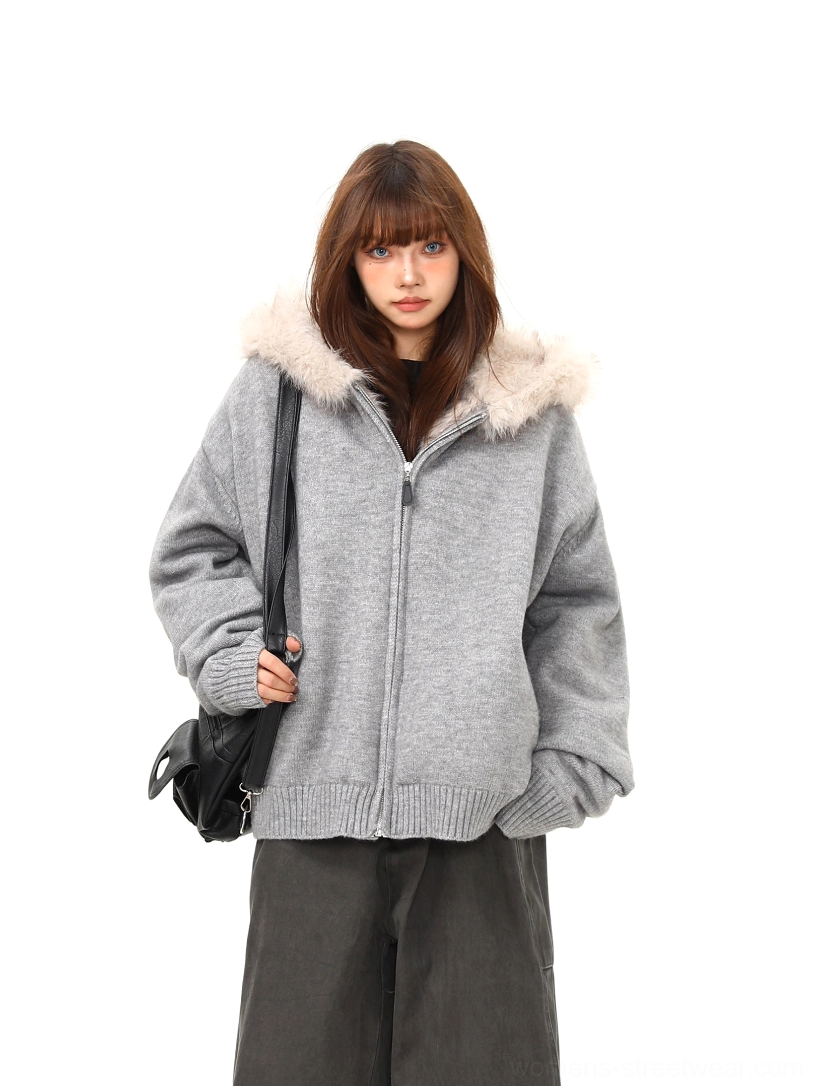 Side view of women's heather gray oversized hooded knit jacket with ribbed cuffs and faux fur trim