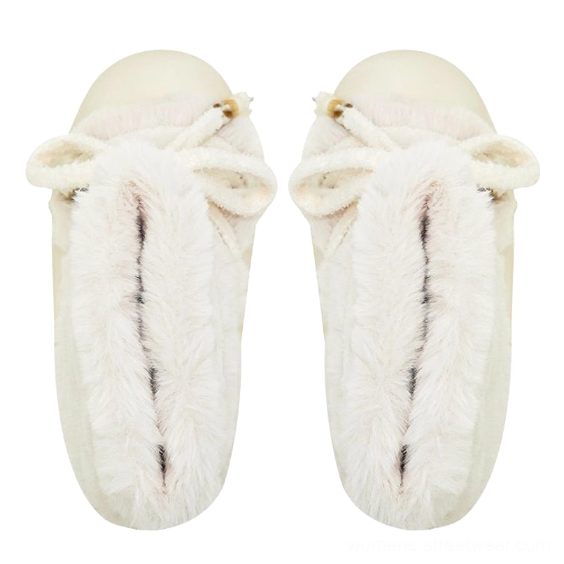 Faux fur platform snow boot detail showing plush shaft, decorative bead-tipped laces, and oversized sculpted sole