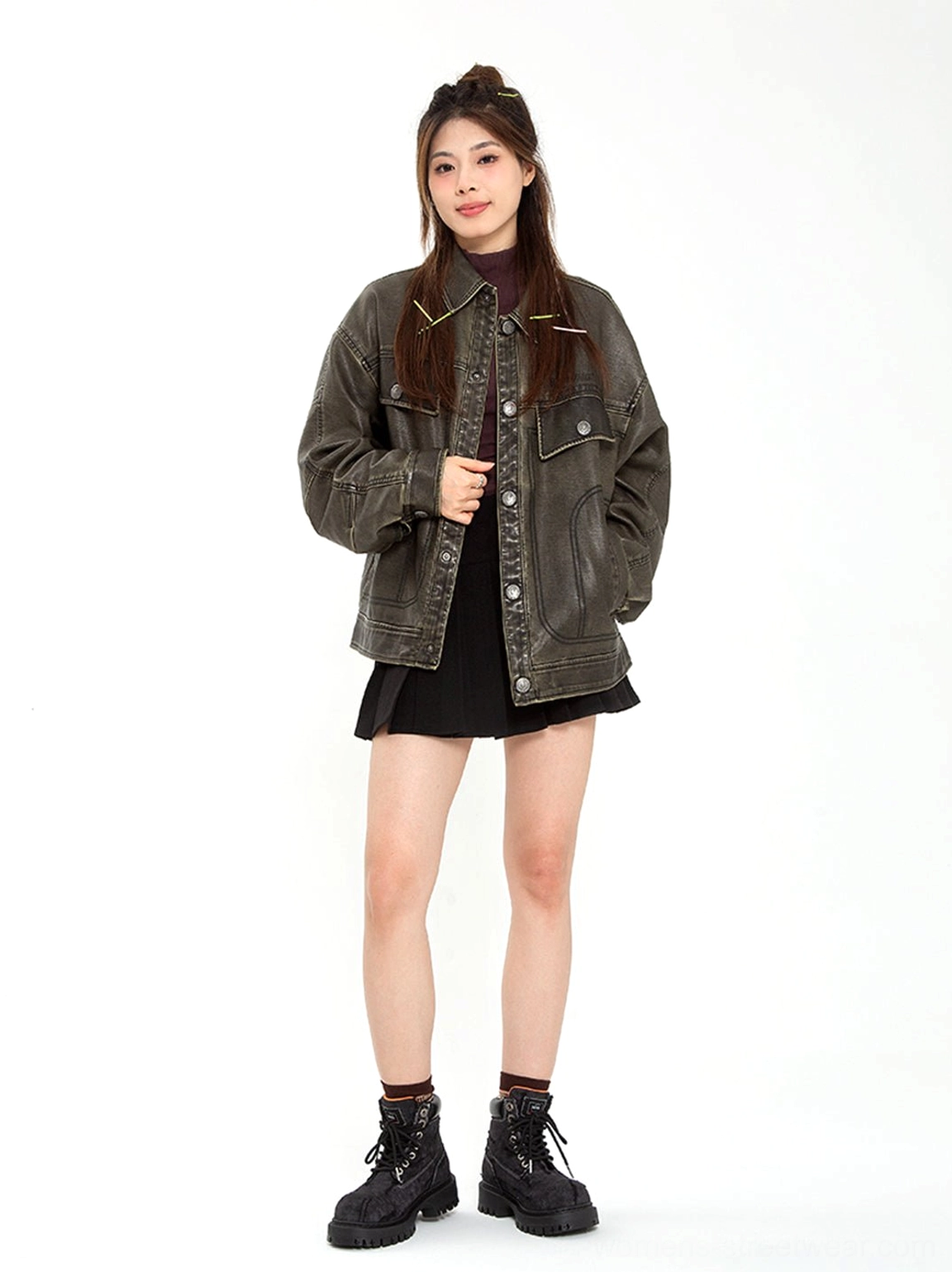 Female model wearing black distressed platform combat boots with an olive jacket and black mini dress urban street style