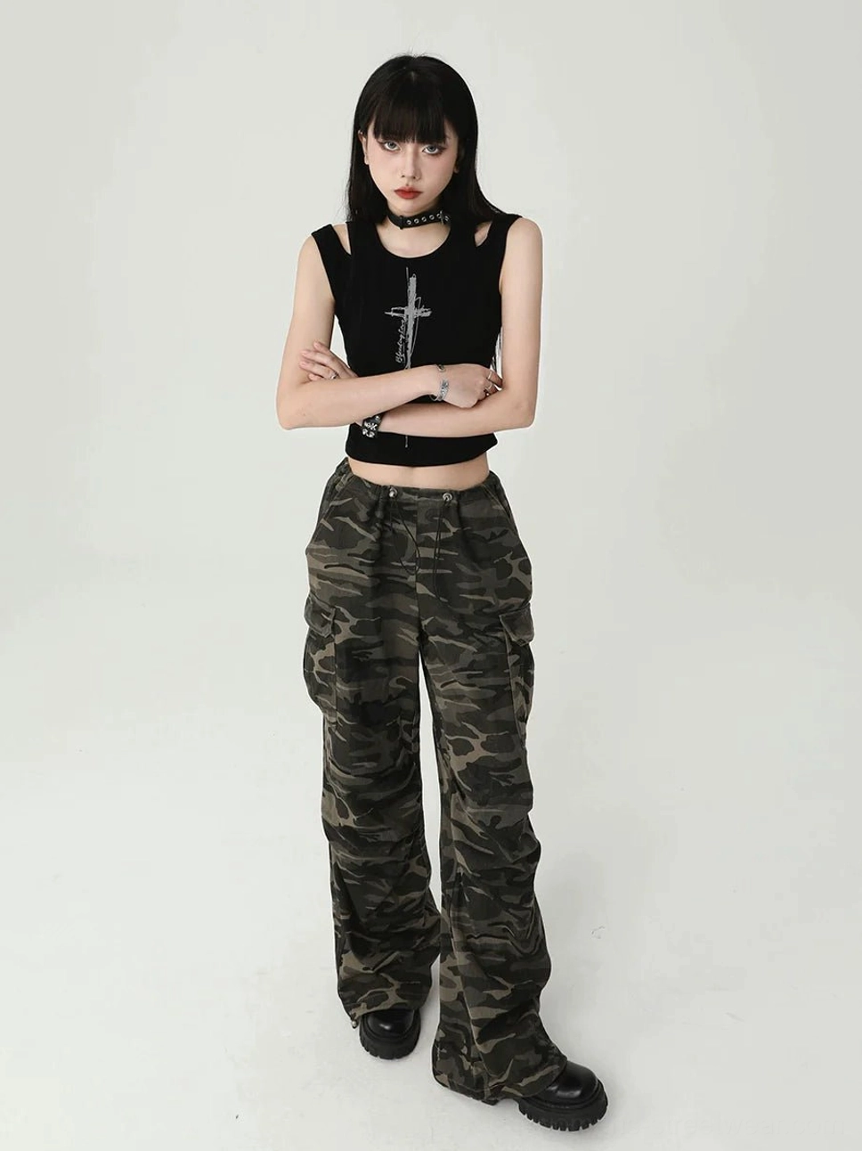 Front view of a fitted black gothic cross tank top with dual shoulder cutouts, crew neckline, cropped hem, and punk fashion styling