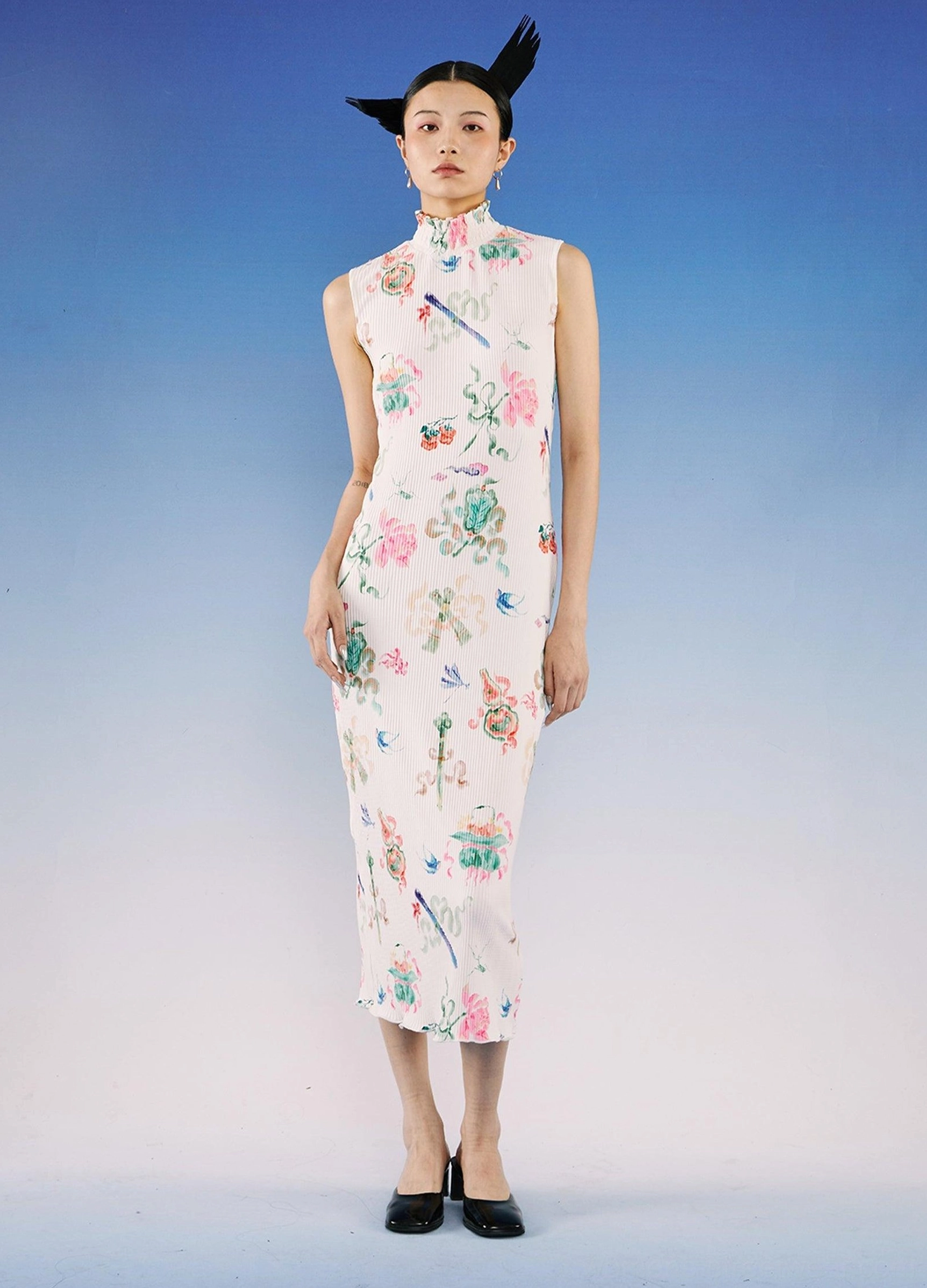 Fitted white floral qipao-inspired midi dress with sleeveless stand collar design and hand-painted style flowers shown in a full-body studio portrait