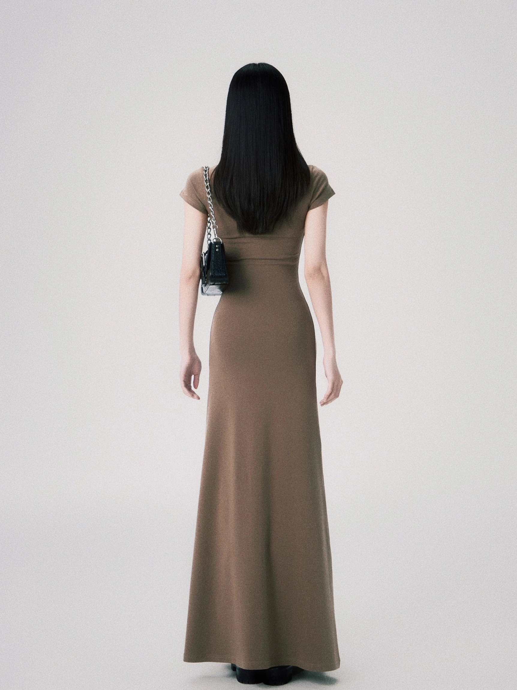 Fitted women’s maxi evening gown with soft matte knit fabric and understated butterfly chest decoration