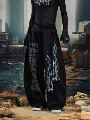 Black flame sash puddle wide-leg fleece streetwear pants front product view with silver graphic lettering