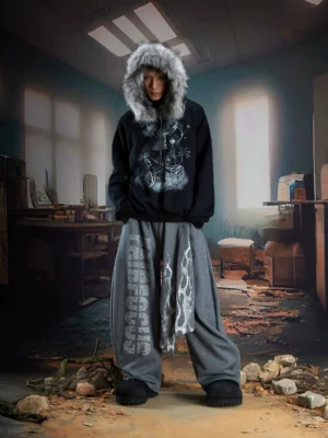 Gray flame sash wide-leg fleece streetwear pants styled with fur-trim hoodie in industrial setting