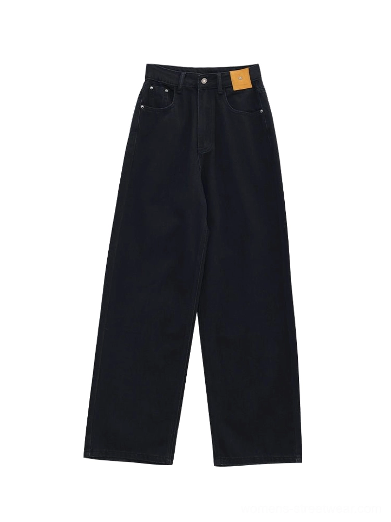 Flat lay view of high-waisted dark blue wide-leg jeans featuring belt loops, five-pocket styling, waistband patch detail, and a clean denim finish