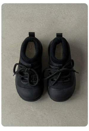 Top-down view of all-black fleece-lined platform sneakers with rounded toe, lace-up front, soft fuzzy collar, and chunky treaded rubber outsole