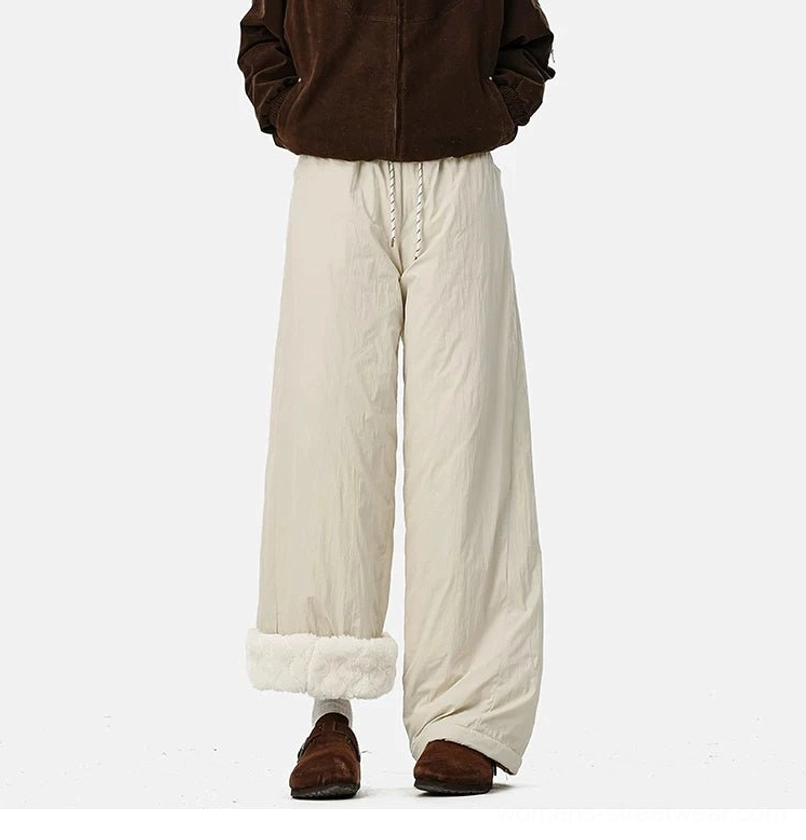 Fleece-lined winter streetwear pants with crinkled outer fabric, roomy wide legs, and versatile rolled hems