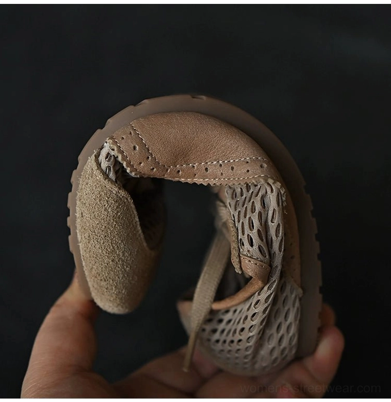 Flexible beige mesh suede sneaker held from the side to show the foldable outsole, breathable interior, and suede upper accents