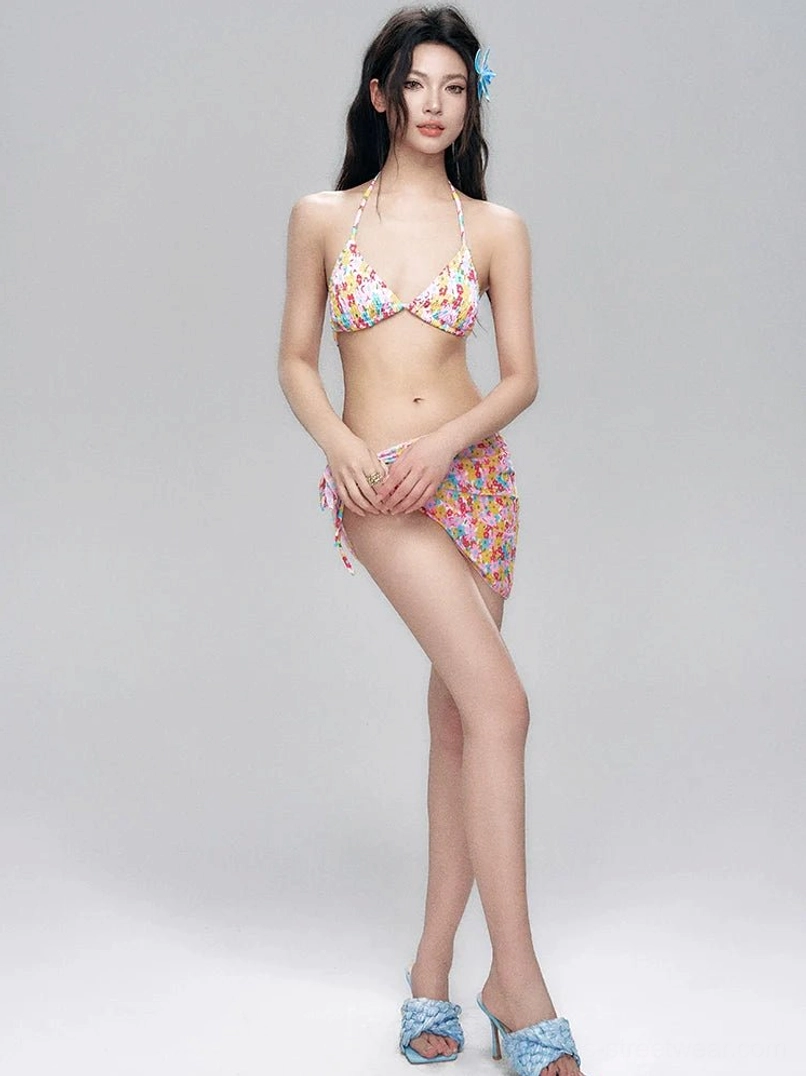 Side view of a floral bikini set styled with a matching wrap sarong covering one hip