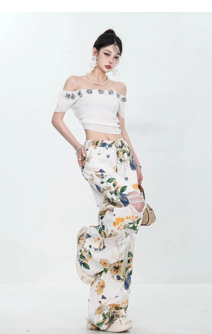 Floral distressed denim streetwear pants with relaxed wide-leg cut and practical pockets