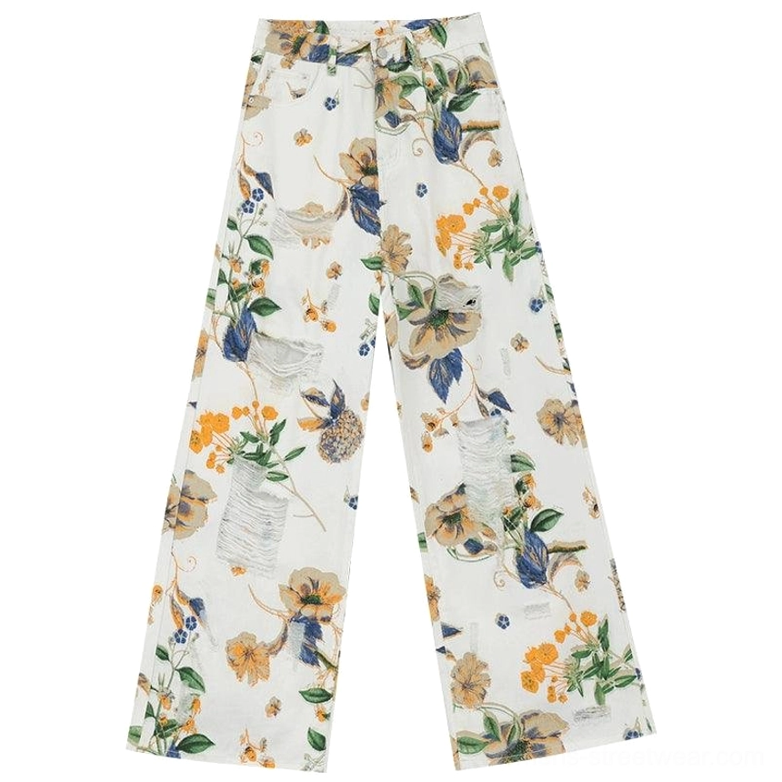 Floral distressed wide-leg denim pants with bold print and relaxed fashion-forward silhouette