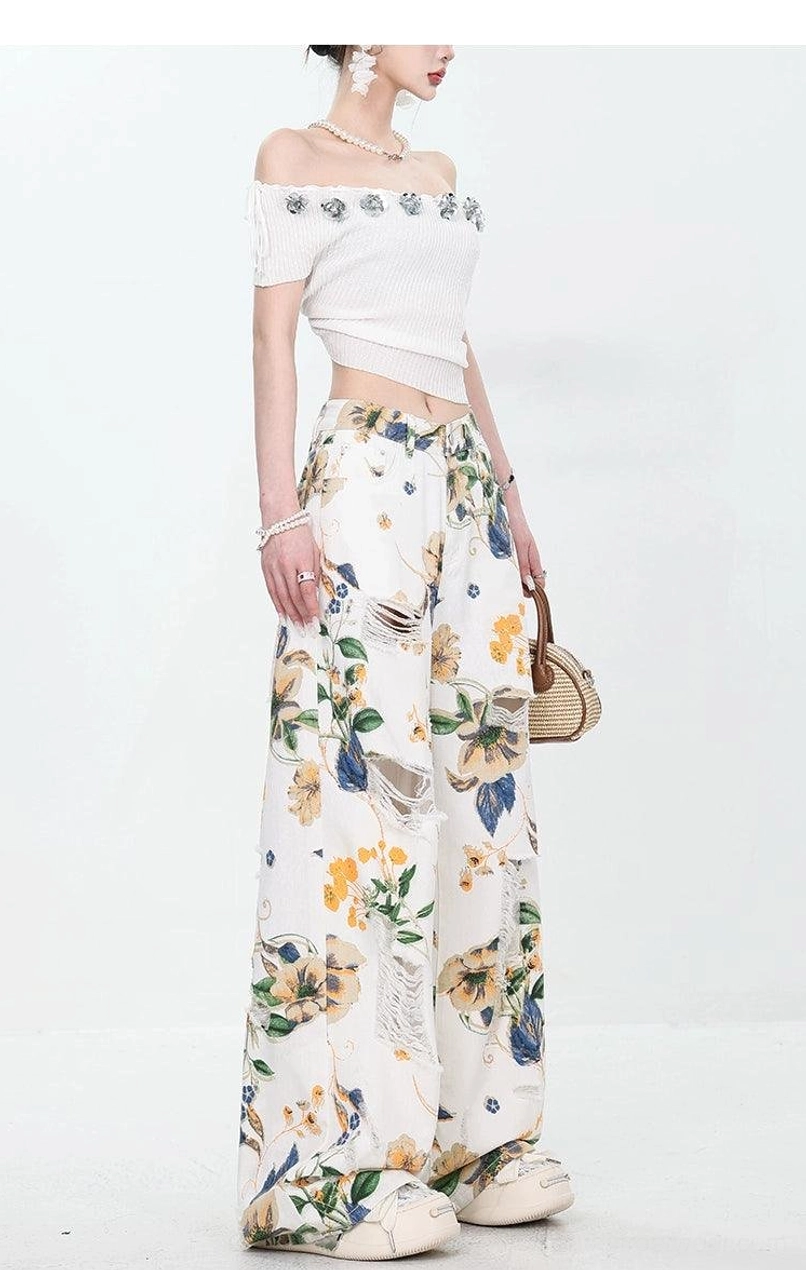 Side back view of floral distressed wide-leg jeans paired with an off-shoulder cropped top