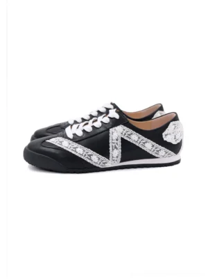 Black and white floral lace microfiber leather low-profile sneakers with contrast panels, white laces, gum sole, and heel bow detail