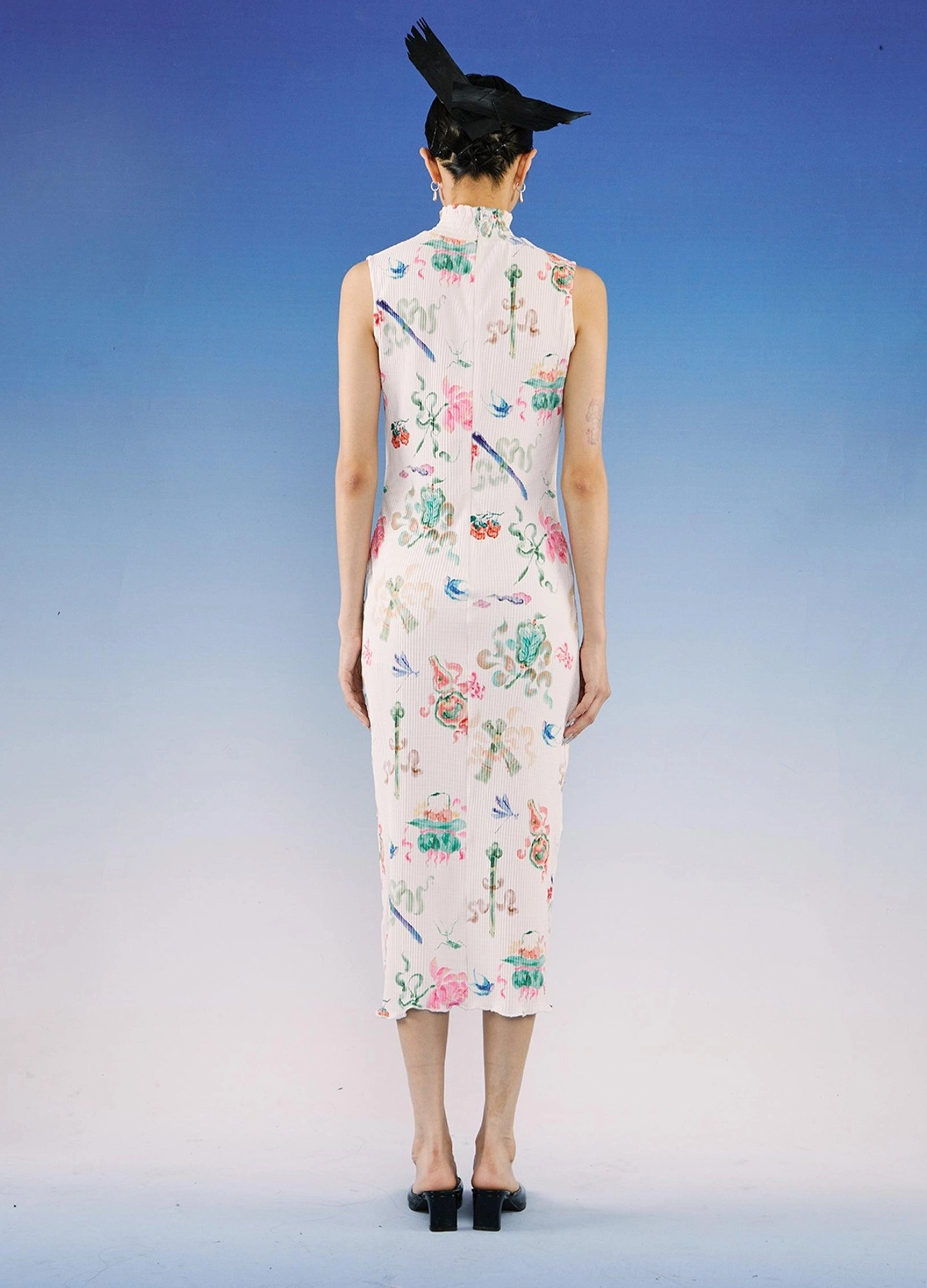 Back view of fitted sleeveless qipao midi dress with full watercolor floral print, high stand collar, and ribbed white fabric