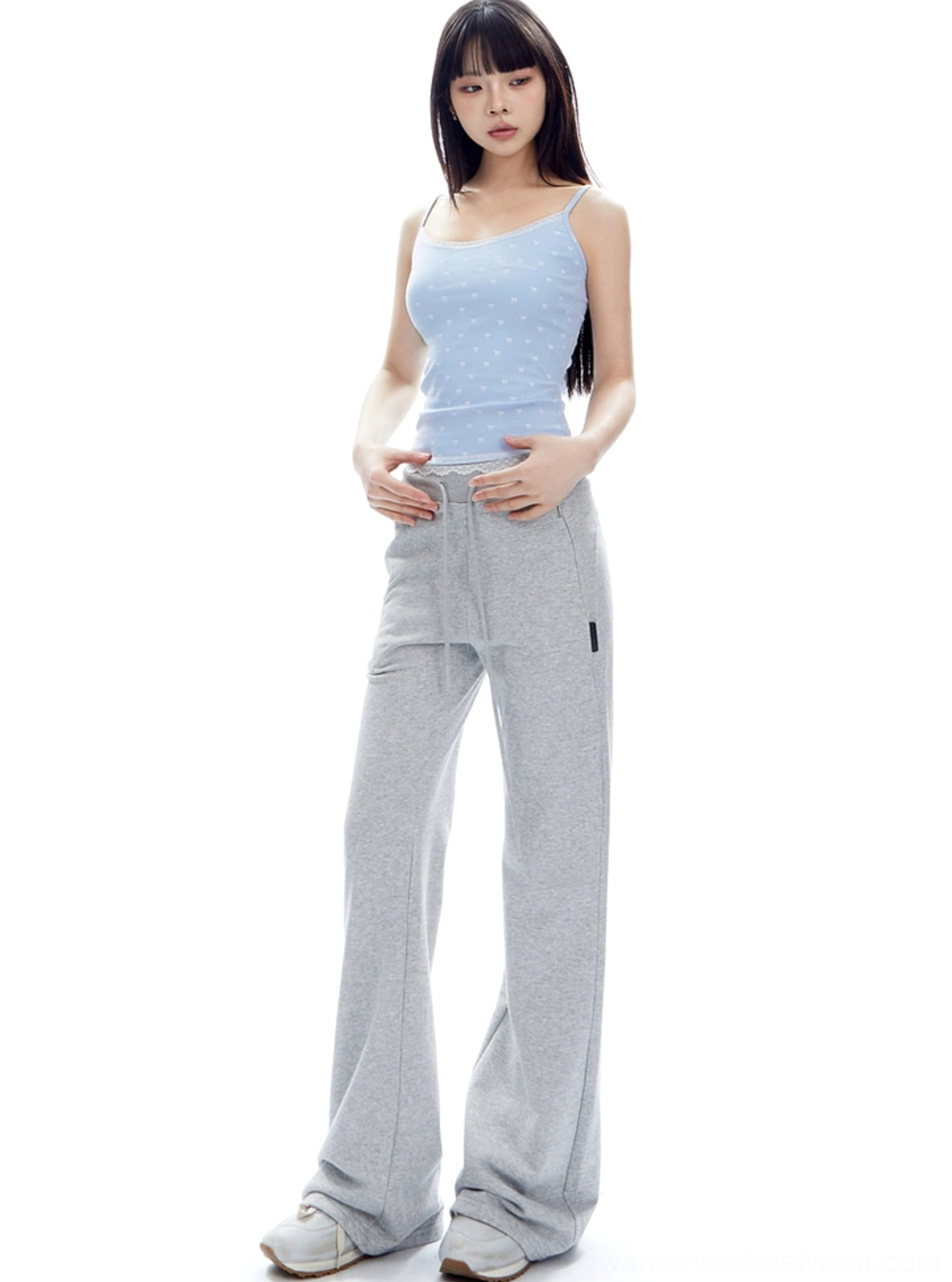 Flower Ash flared streetwear sweatpants shown from a side three-quarter angle with vertical leg seam and long flowing silhouette