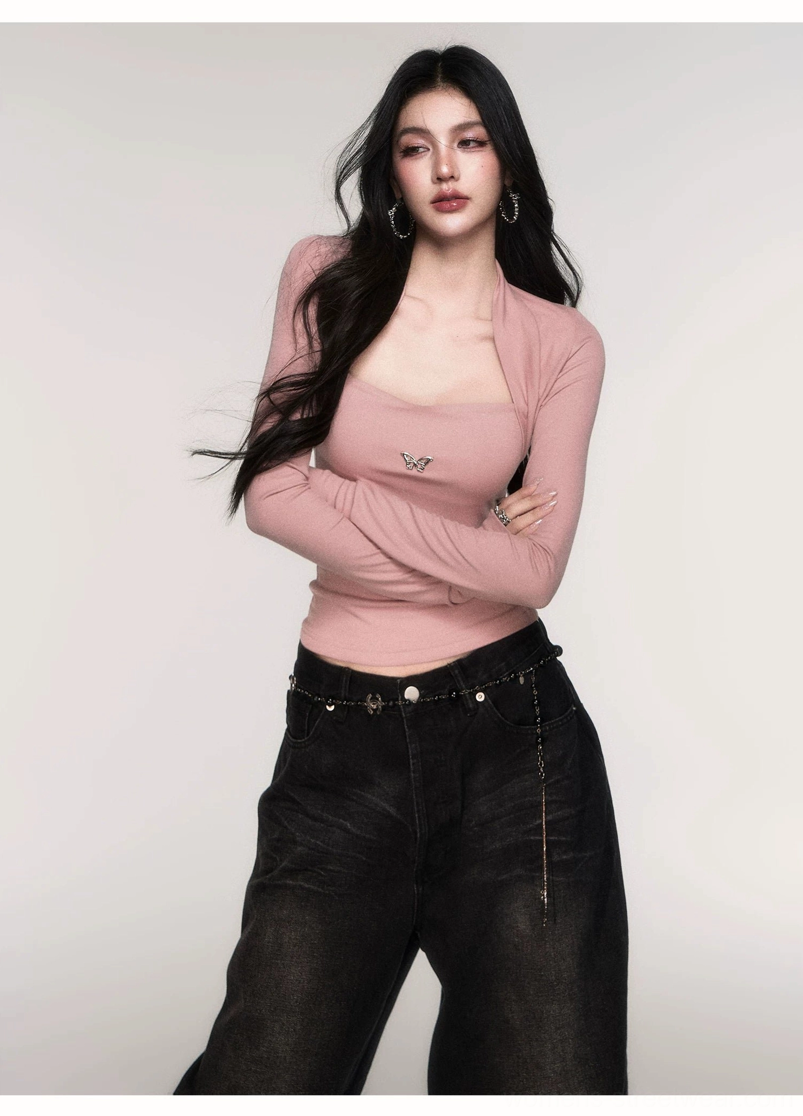 Flower Gray Acubi butterfly emblem ribbed knit top with attached shrug, square neckline, exposed shoulders, fitted long sleeves, and black wide-leg jeans