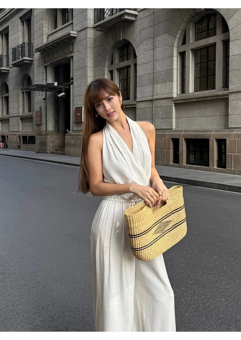 Flowing wide-leg jumpsuit with draped halter neckline for summer streetwear and resort styling
