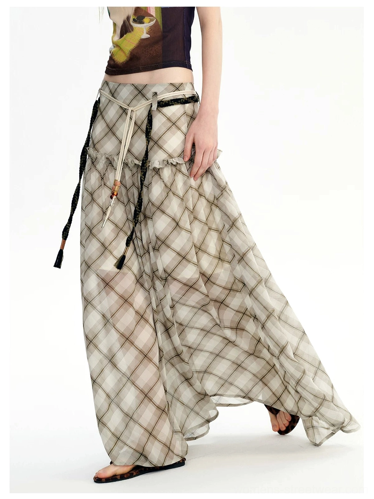 Side view of a flowy neutral plaid maxi skirt in lightweight chiffon styled with relaxed contemporary streetwear