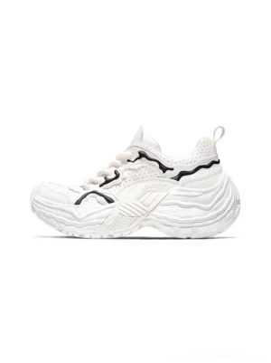 White Flux Form sculpted leather chunky sneakers with black flowing accents and rippled platform outsole side three quarter studio view