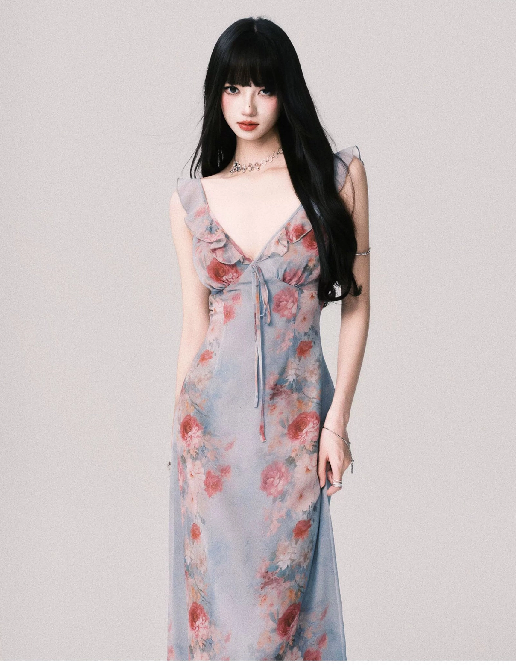 Close front view of foggy blue floral maxi slip dress showing the deep V bodice ruffled straps and adjustable front tie