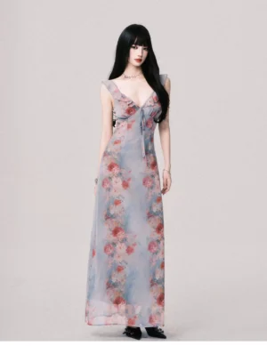 Foggy blue floral Y2K maxi slip dress shown from the front with ruffled straps deep V neckline front tie and floor length rose print skirt