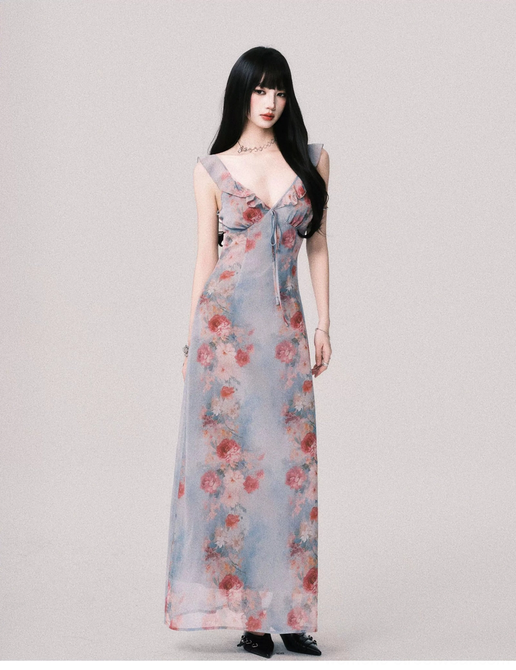 Foggy blue floral Y2K maxi slip dress shown from the front with ruffled straps deep V neckline front tie and floor length rose print skirt
