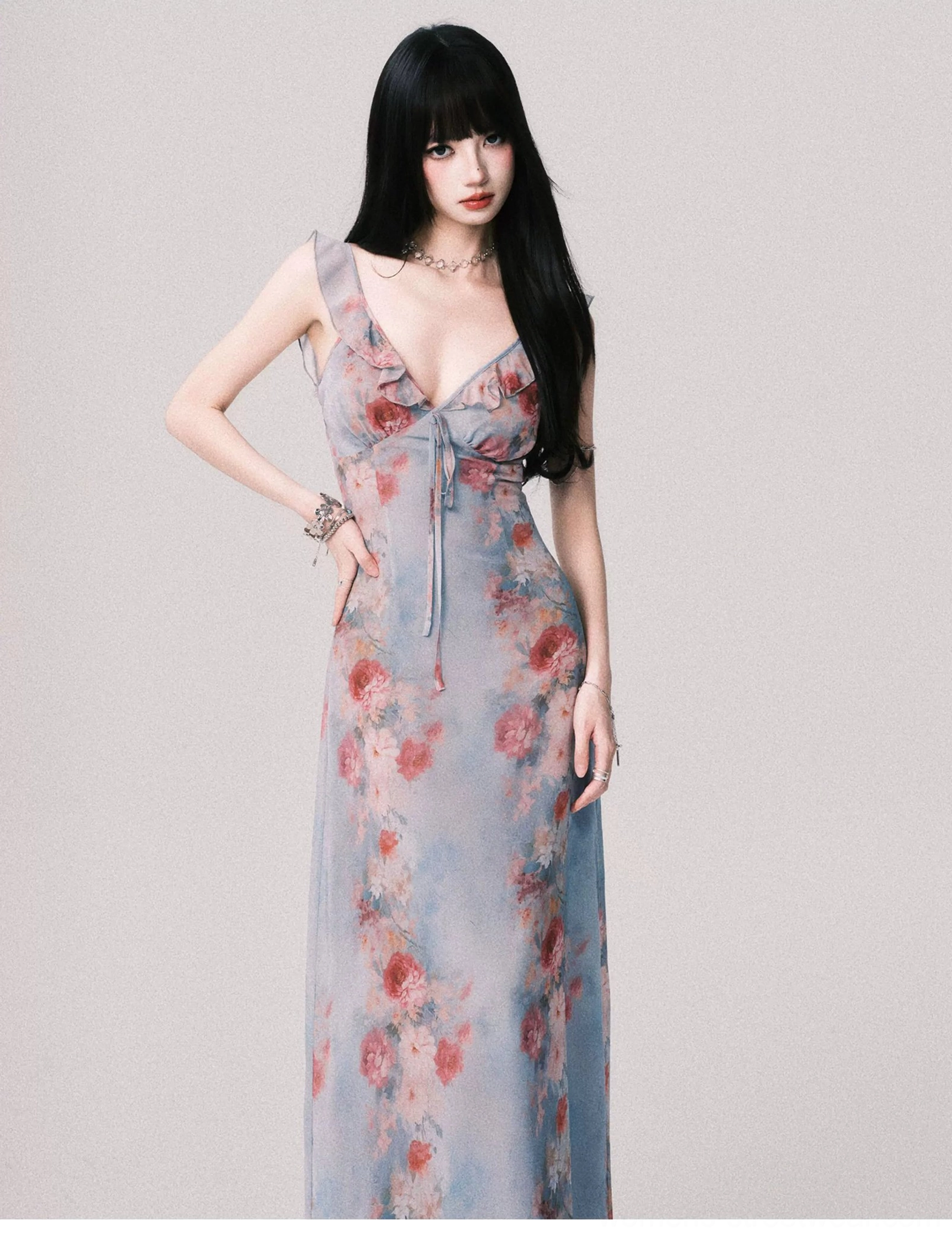 Foggy blue rose print maxi slip dress shown from a three-quarter front angle with slim silhouette deep V neckline and tie detail