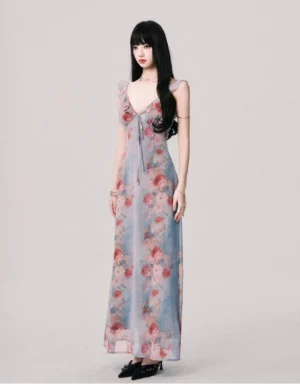 Foggy blue vintage floral maxi dress shown from a three-quarter side angle with fitted waist flowing skirt and romantic rose print