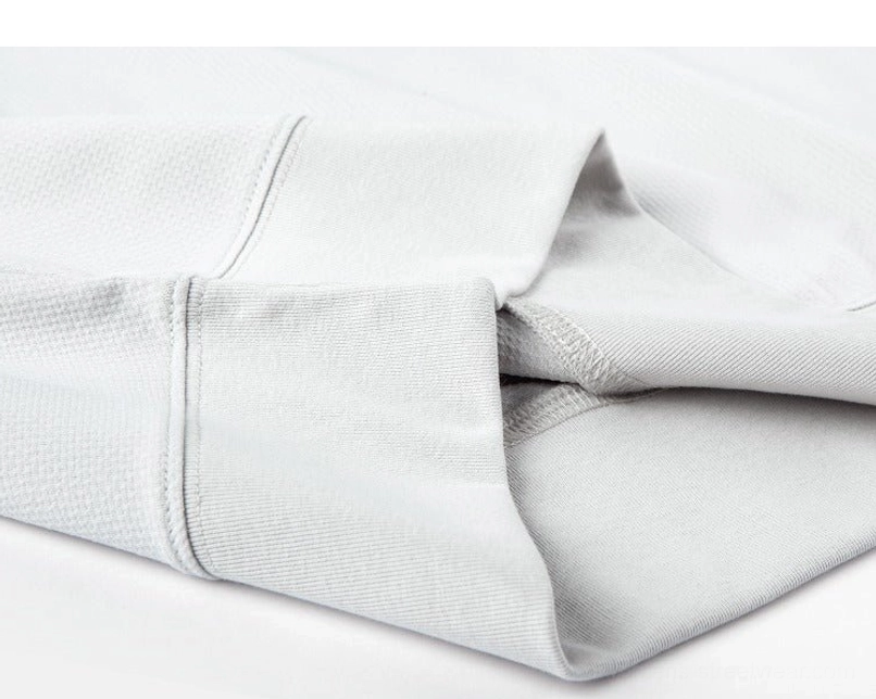 Folded light gray oversized relaxed fit sweater tee showing structural seams and draped polyester fabric