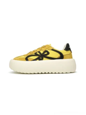 Yellow and black four-leaf chunky platform sneakers shown in side profile with lace-up upper and textured off-white platform sole