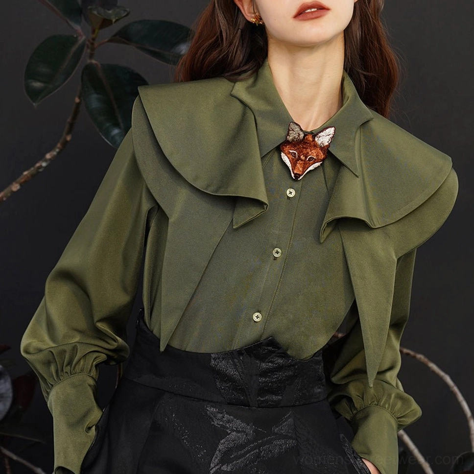 Close up of dark green fox charm blouse showing embroidered fox collar detail, gathered lantern cuffs, and smooth fabric