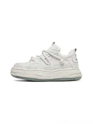 All-white frayed canvas platform sneakers in side profile with thick sculpted chunky sole and twisted laces