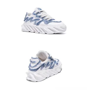 Blue and white frayed denim wave chunky sole streetwear sneakers shown from rear three-quarter angle