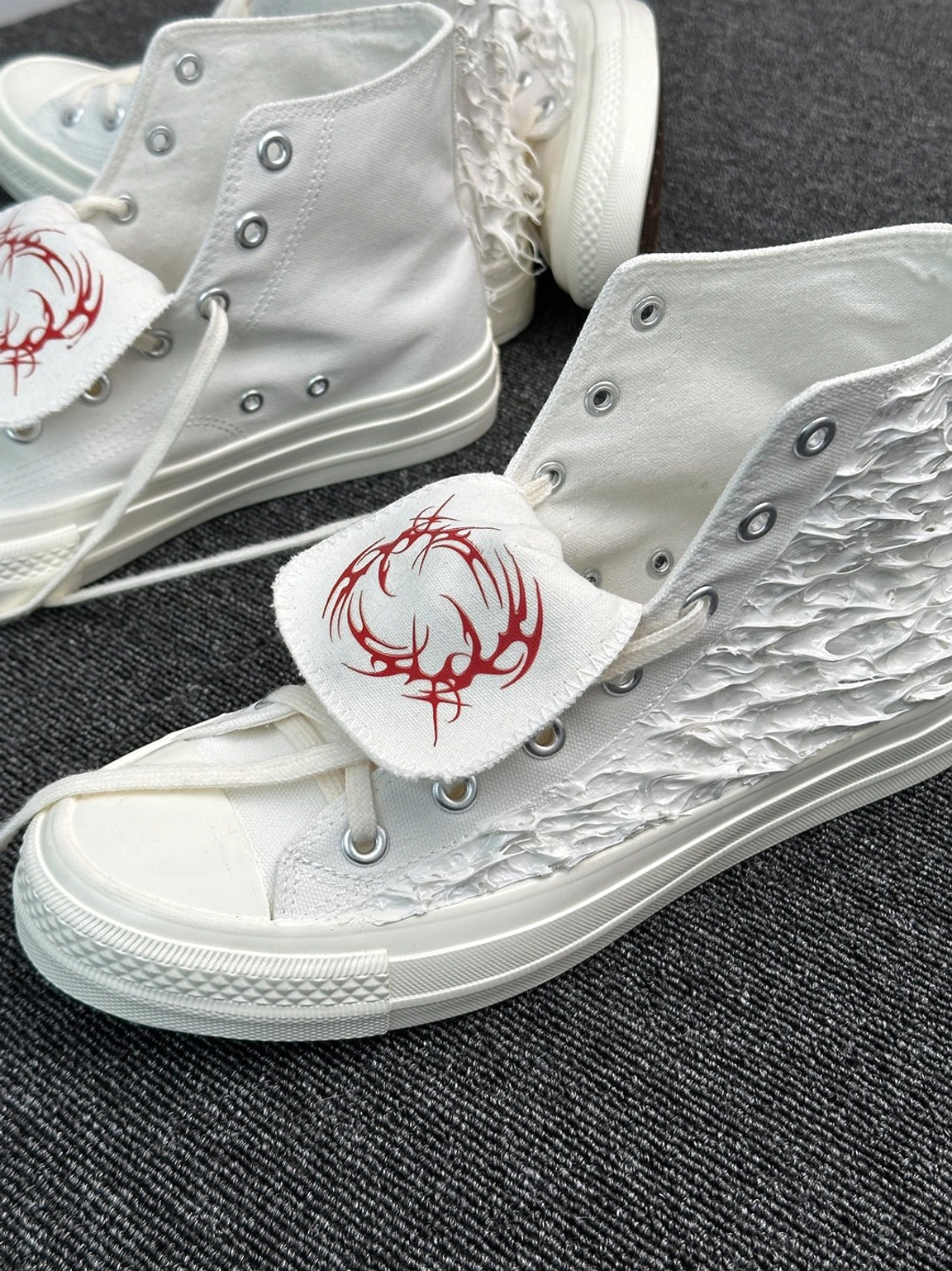 Fringed high-top canvas sneakers with textured tassel upper, lace-up closure and rubber toe cap