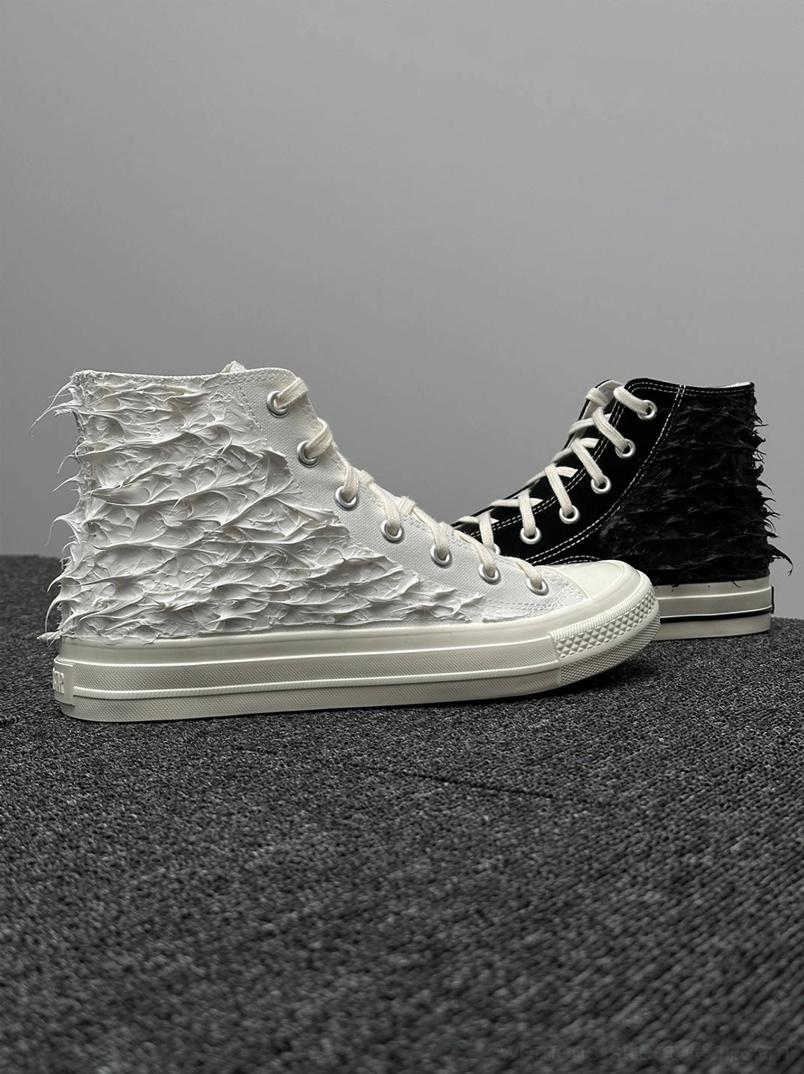 Fringed high-top canvas sneakers with tribal-inspired red detail, metal eyelets and classic rubber toe cap