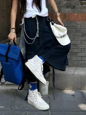 White fringed high-top canvas sneakers styled with white crew socks, denim skirt and Y2K streetwear accessories