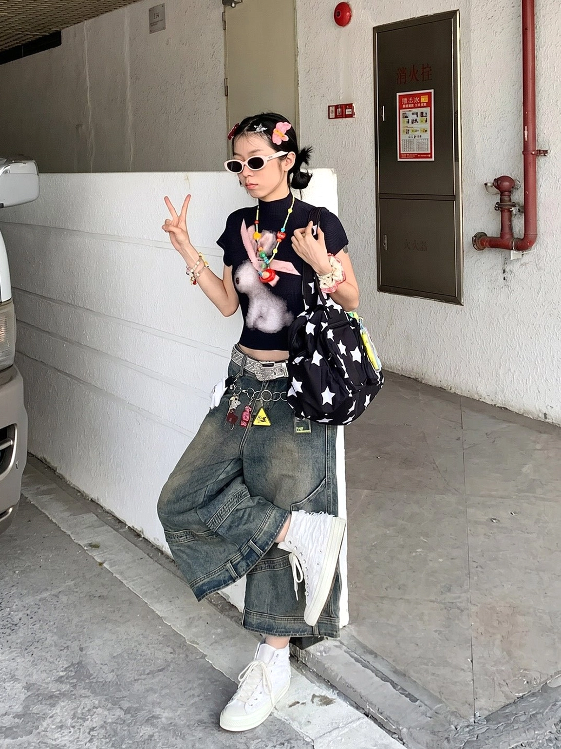 White fringed high-top canvas sneakers paired with wide-leg jeans in a casual Y2K streetwear outfit