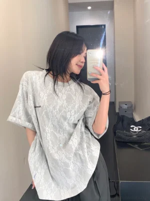 Grey frosted vein lace texture oversized streetwear t-shirt shown in a side mirror outfit view with a dark skirt
