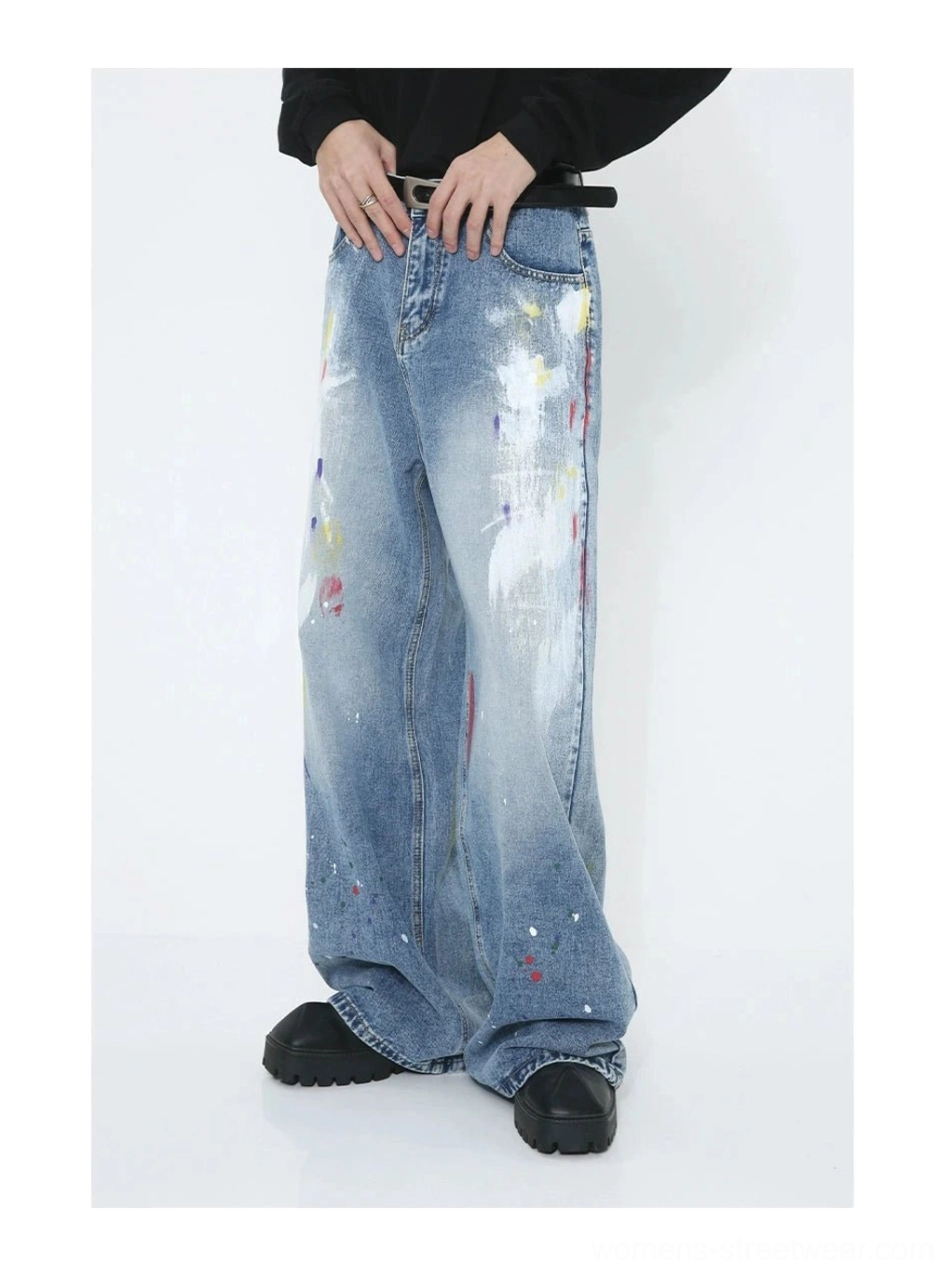Full-length avant-garde denim jeans with wide-leg tailoring, faded blue wash, white brush-effect panels and colorful splash graphics