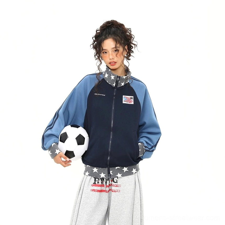 Fully zipped blue star print colorblock varsity track jacket styled with a soccer ball for a retro athletic streetwear look