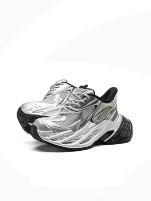 Futuristic silver metallic platform runner sneakers with breathable mesh upper, sculpted black sole, and chunky Y2K streetwear design on white background