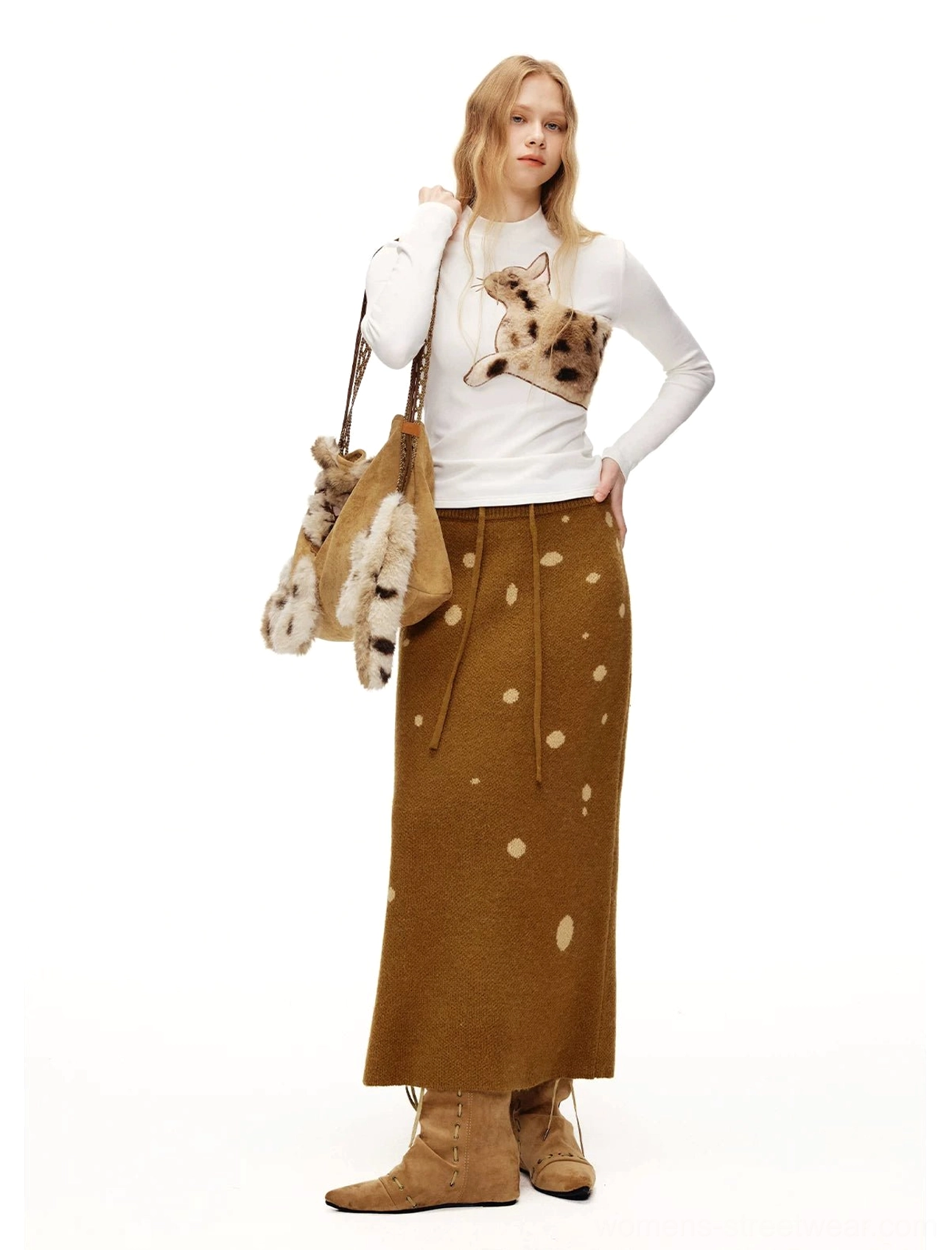 Full-body styling of a white fuzzy cat appliqué long sleeve tee with brown polka-dot midi skirt and plush cat bag