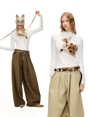 Two models wearing white fuzzy cat mock neck long sleeve streetwear tees with plush cat appliques and wide-leg pants in a studio