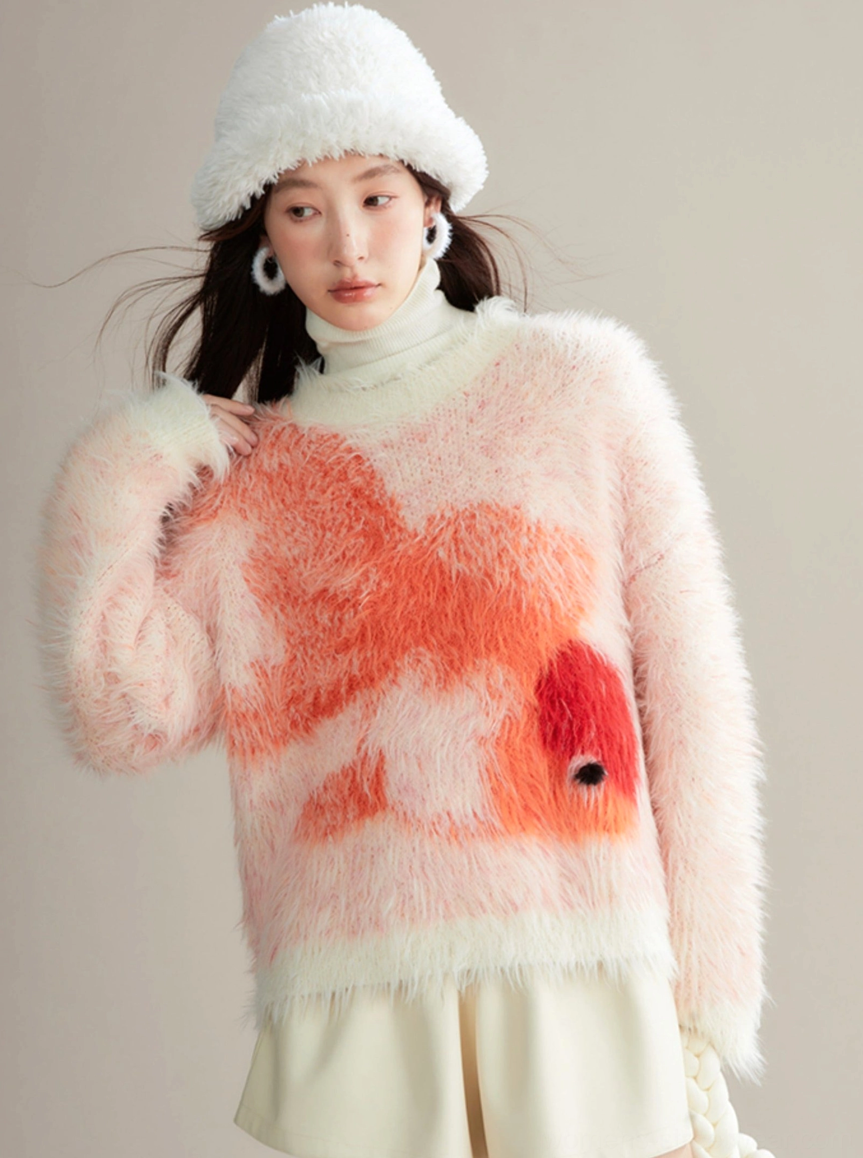 Fuzzy koi knit sweater layered over a turtleneck with a white bucket hat for cozy Korean streetwear styling