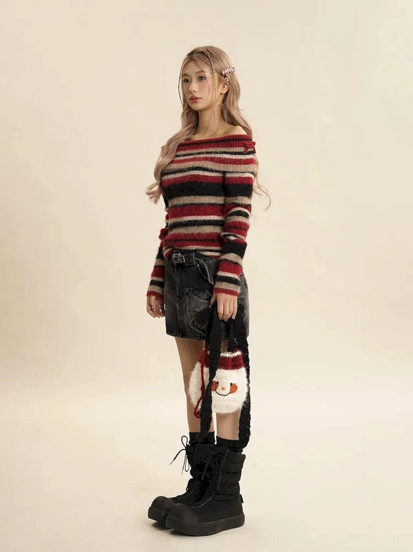 Side full body view of fuzzy red multi-stripe off-shoulder sweater showing wide boat neckline and fitted silhouette