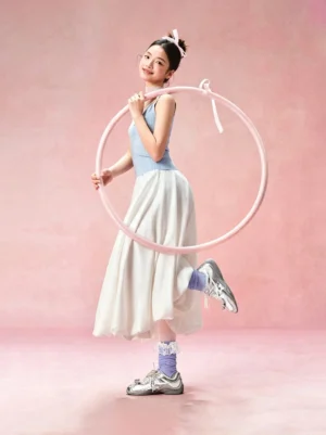 Galaxy silver ballet Mary Jane sneakers worn with ruffled socks in a feminine streetwear outfit, showing the rounded toe and reflective finish